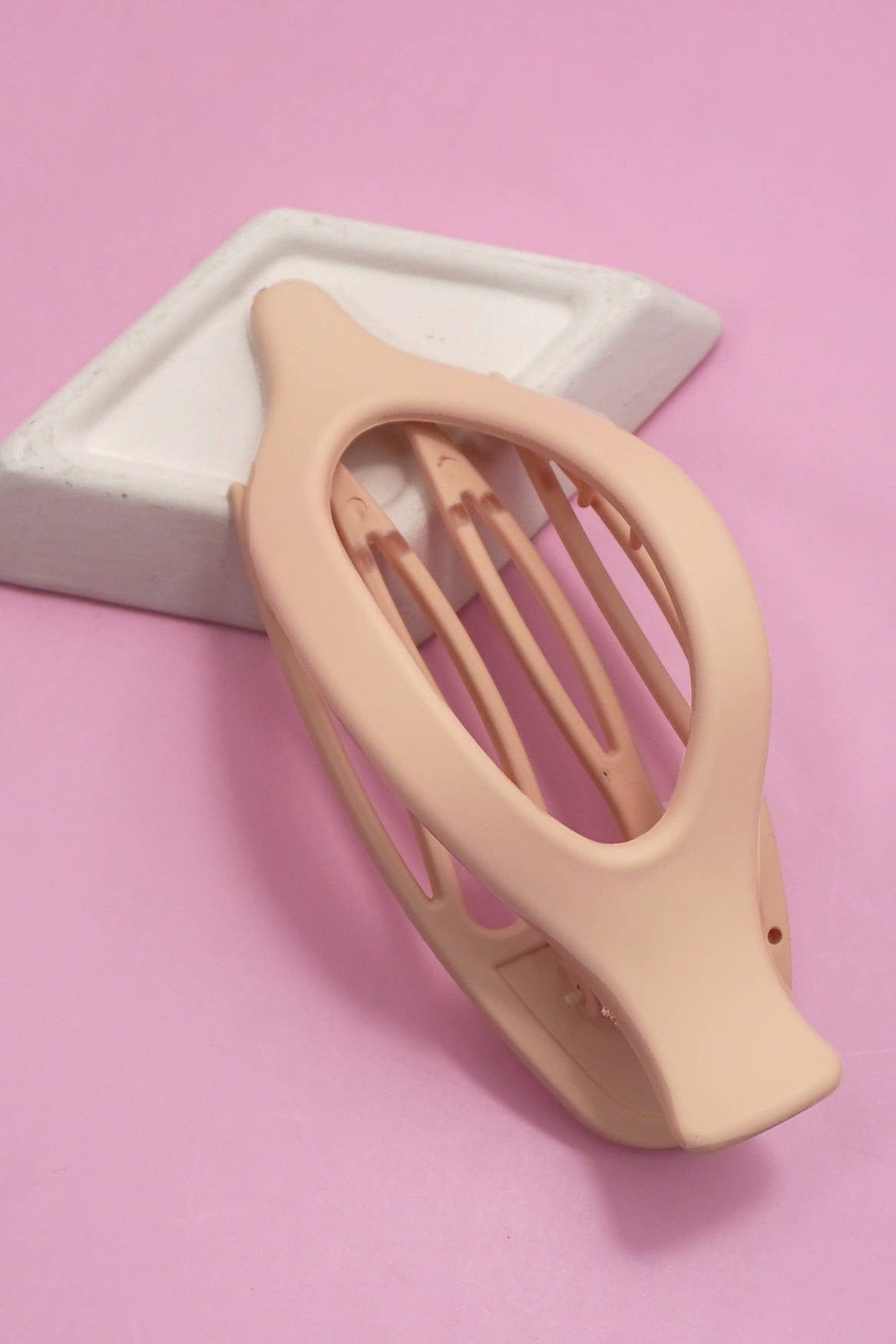 Nude hair clip on a pink background