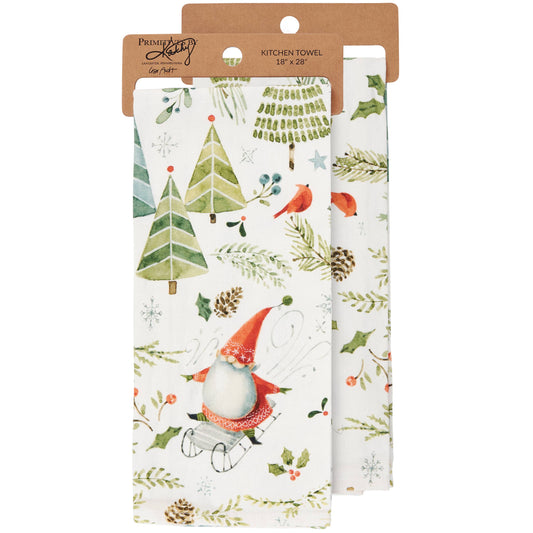 Two kitchen towels with Christmas-themed designs in packaging on a white background