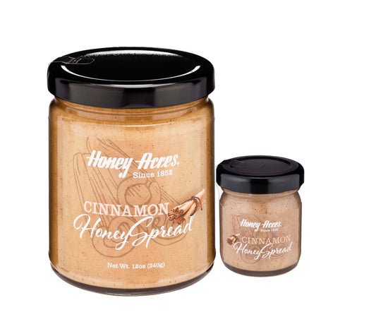 Two jars of Honey Acres Cinnamon Honey Spread on a white background
