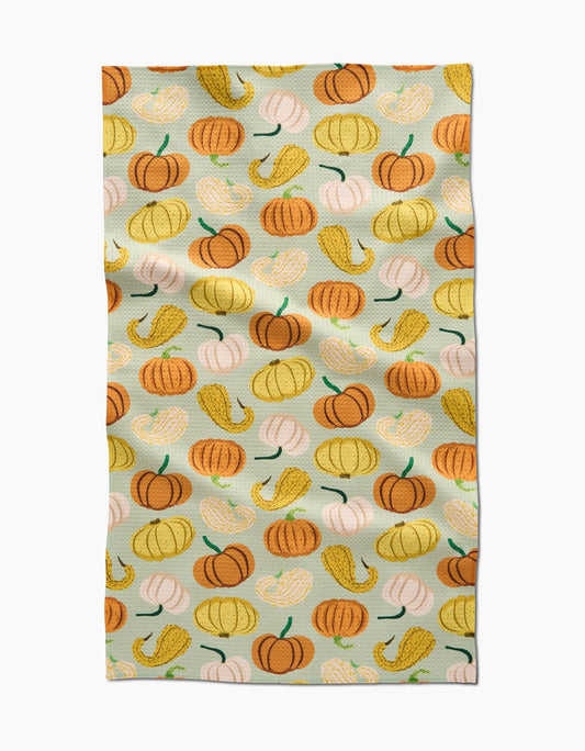 Tea towel with colorful pumpkin pattern on a light blue background