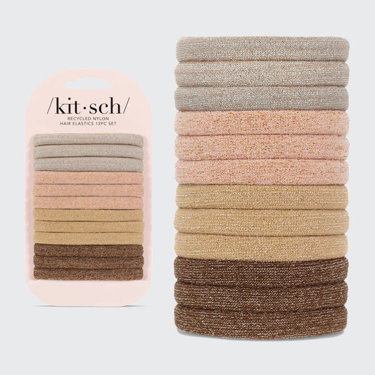 A collection of Kitsch brand glittery nylon hair elastics in various neutral shades, displayed both in a stack and in packaging.