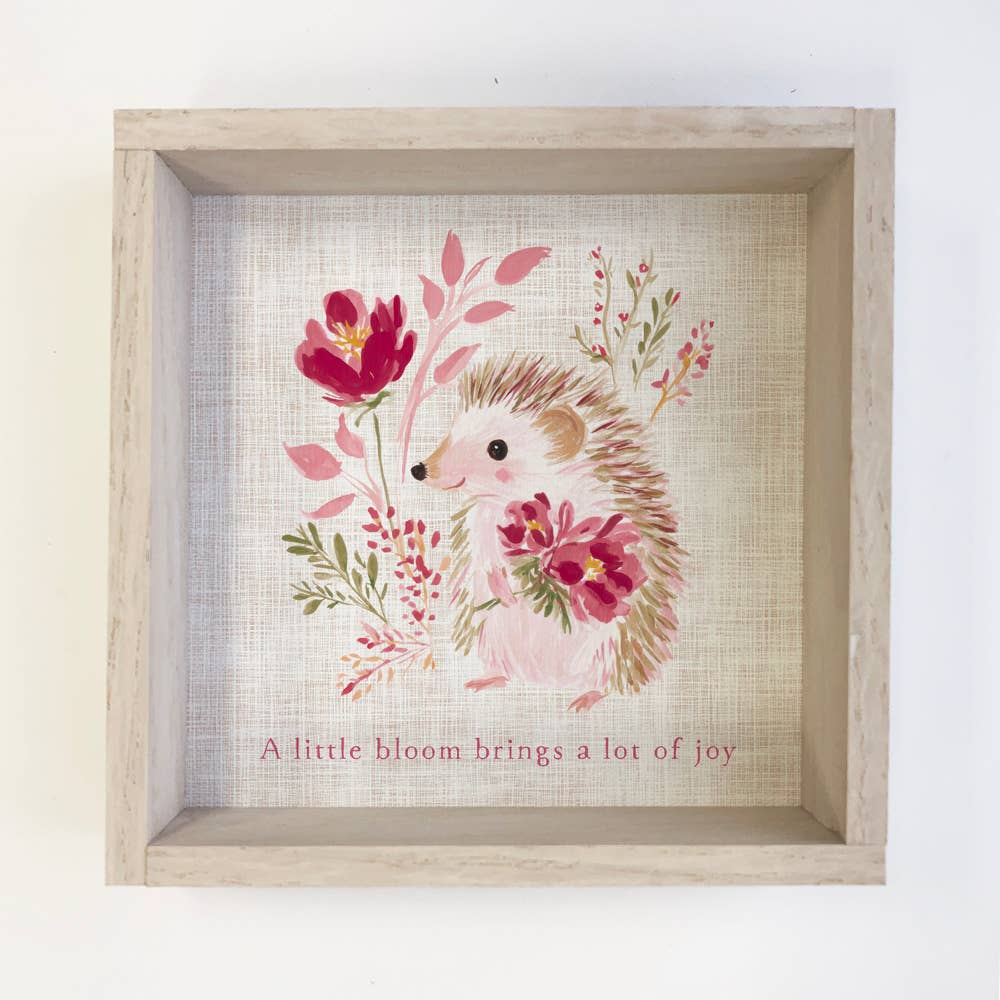 Framed artwork of a hedgehog with flowers and text on a textured background
