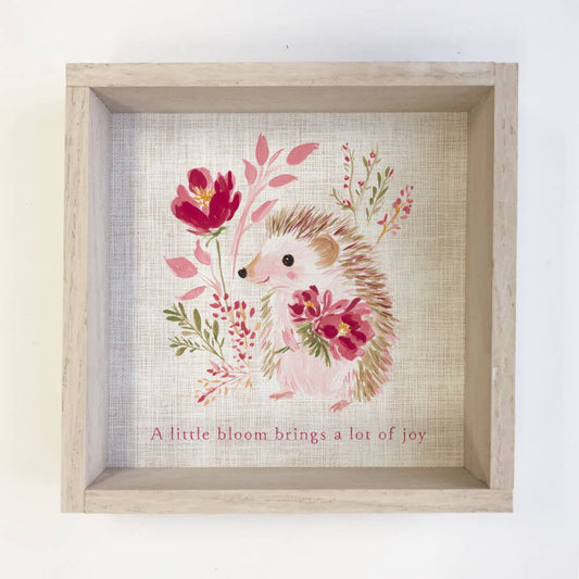 Framed artwork of a hedgehog with flowers and text on a textured background