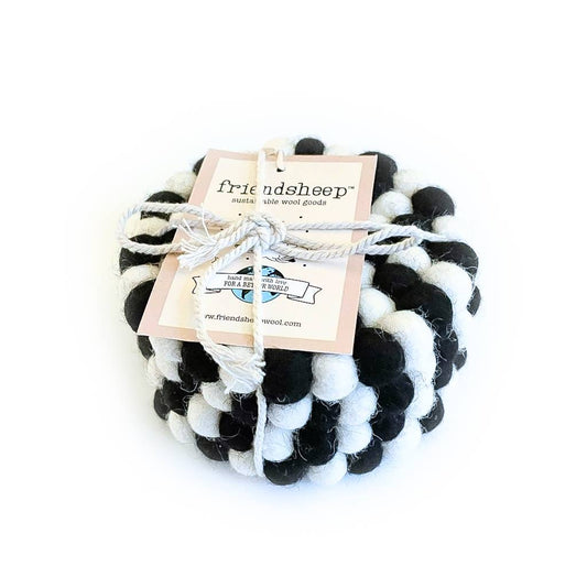 Set of four black and white coasters with a 'friendsheep' label on a white background