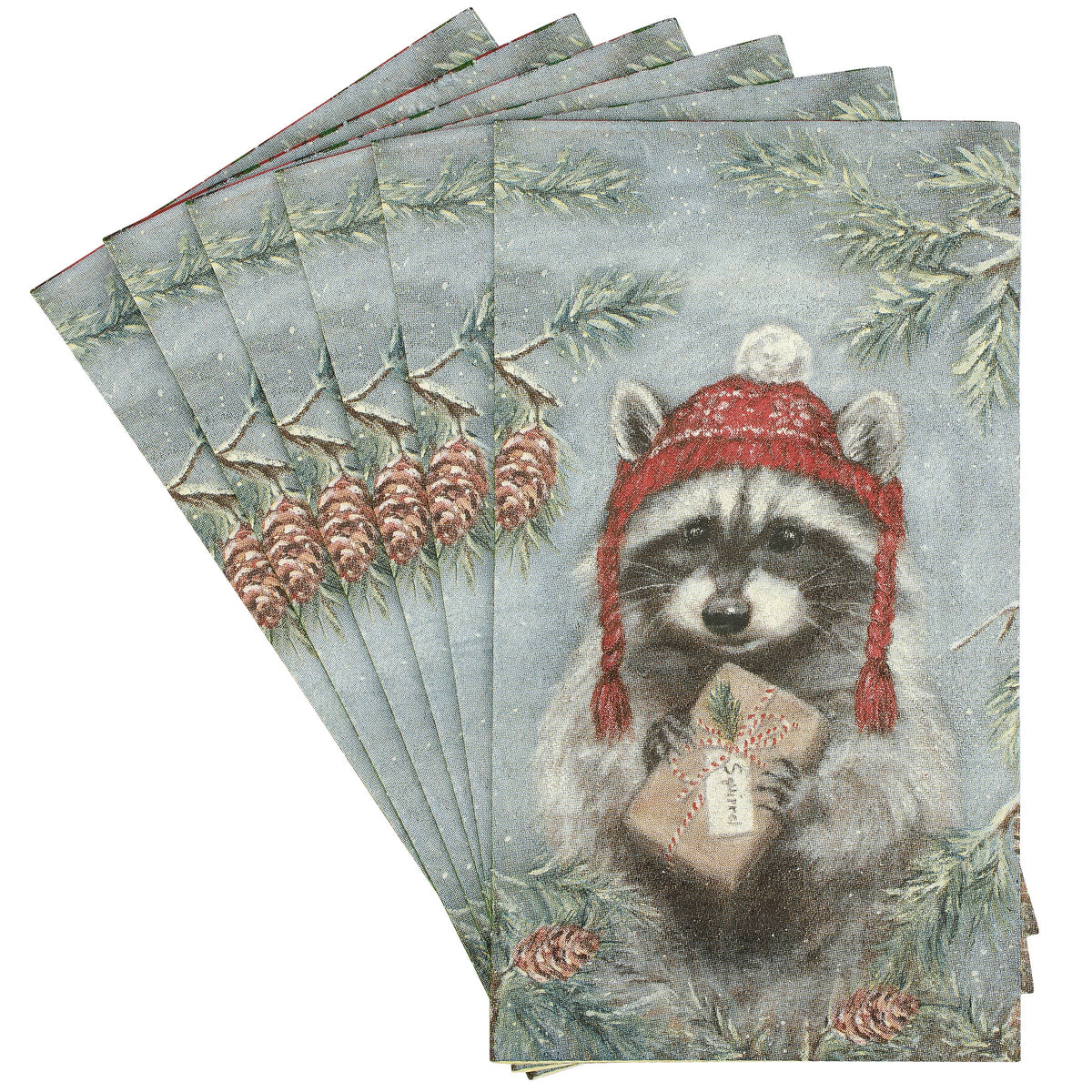 A fan of rectangular paper napkins featuring a vintage-style illustration of a raccoon wearing a red knit hat and holding a wrapped gift, surrounded by pine branches and pinecones on a pale blue-gray background.