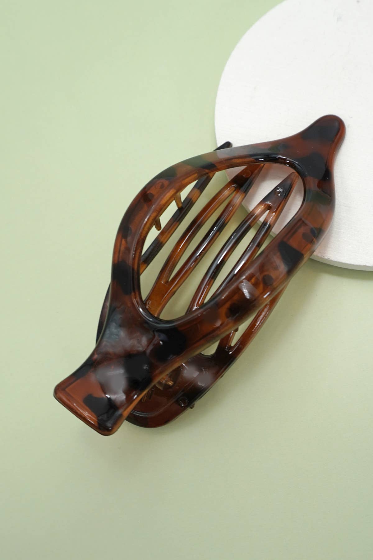 Tortoiseshell hair clip on a light green background
