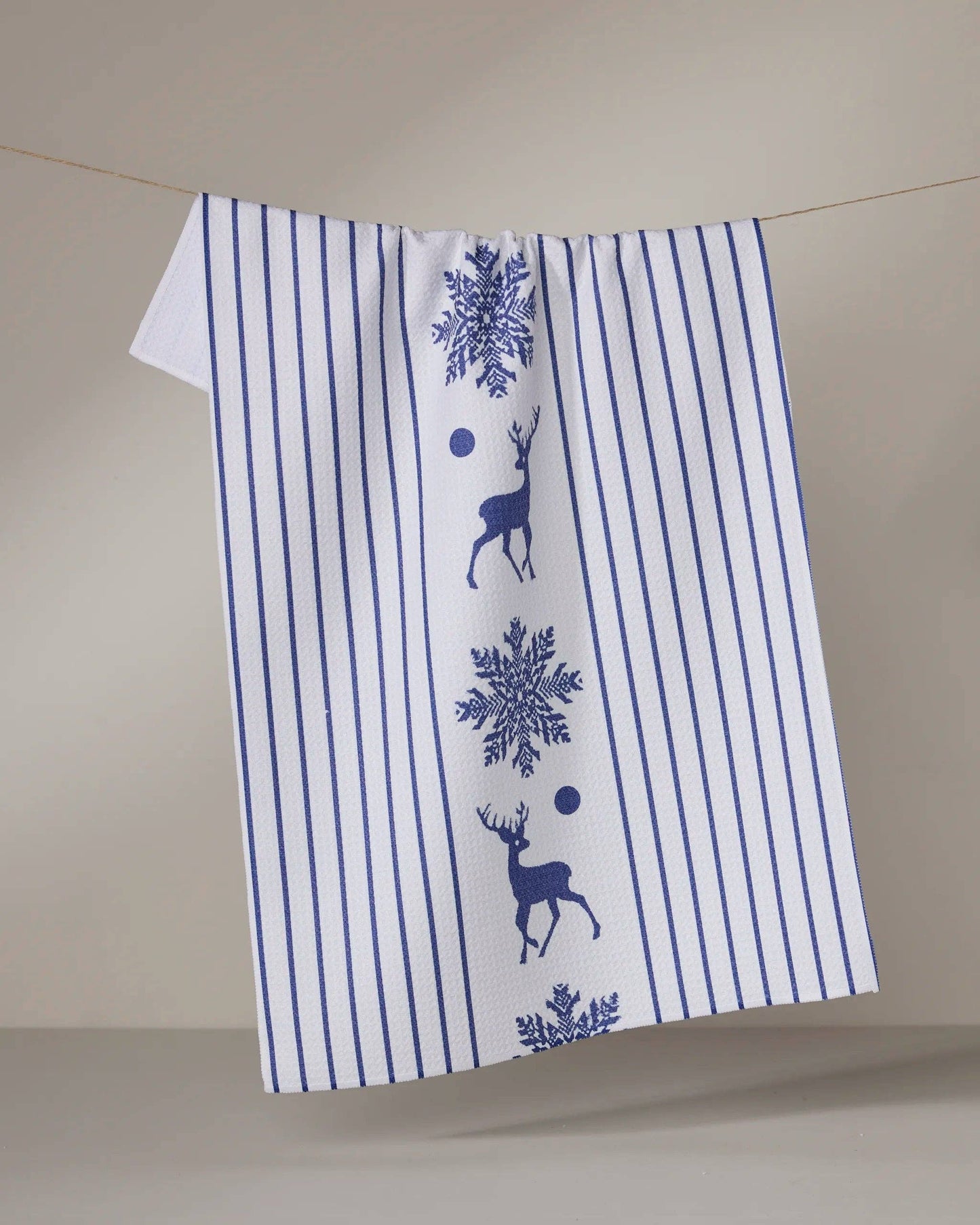 Geometry Tea towel with blue stripes and deer snowflake design on a beige background