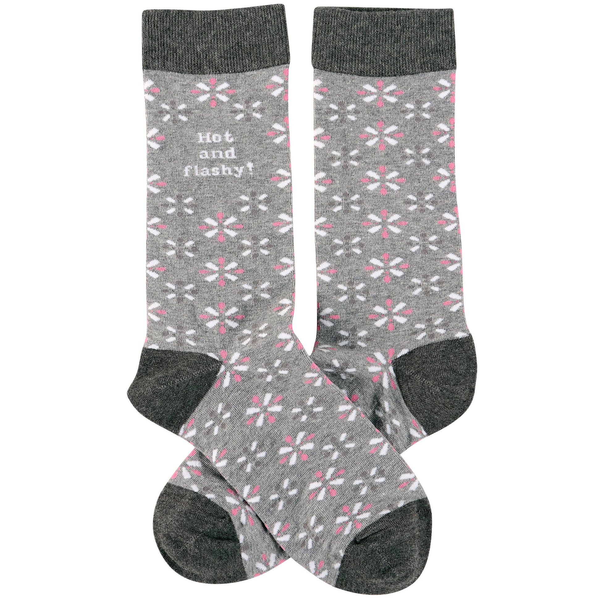 Gray socks with pink floral pattern and black cuffs and toes on a white background