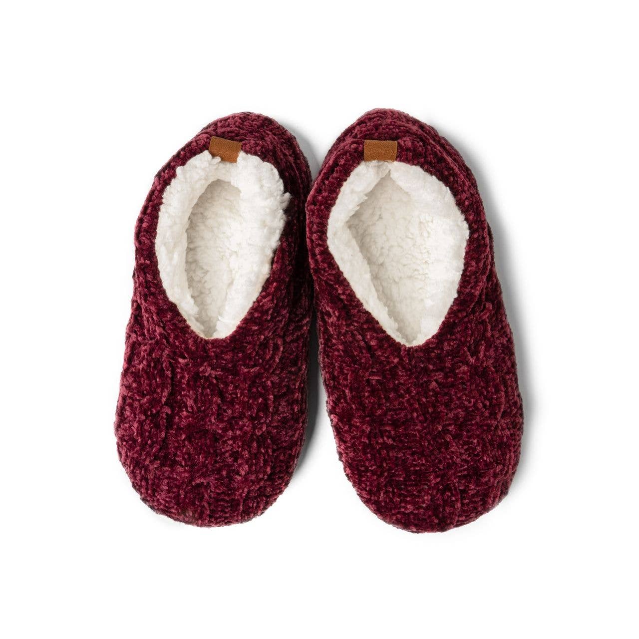 Pair of maroon slippers with white lining on a white background