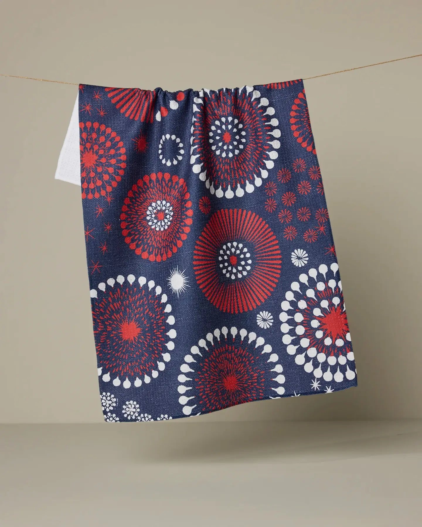 Decorative Geometry towel with red, white, and blue circular patterns on a beige background