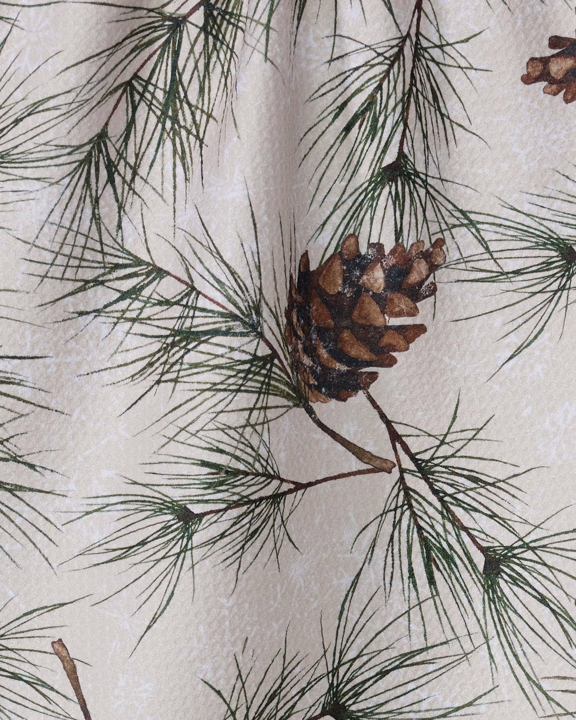 Geometry Tea Towel Evergreen Frost  Pattern of pine branches and cones on a textured background