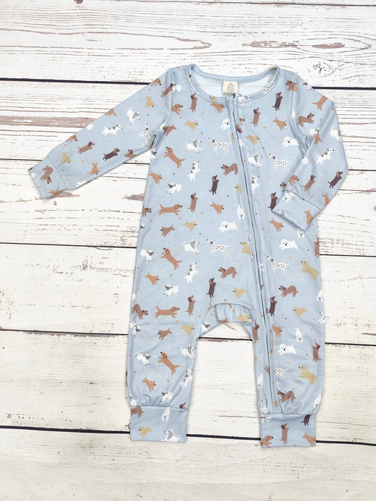 Baby onesie with dog pattern on a wooden surface