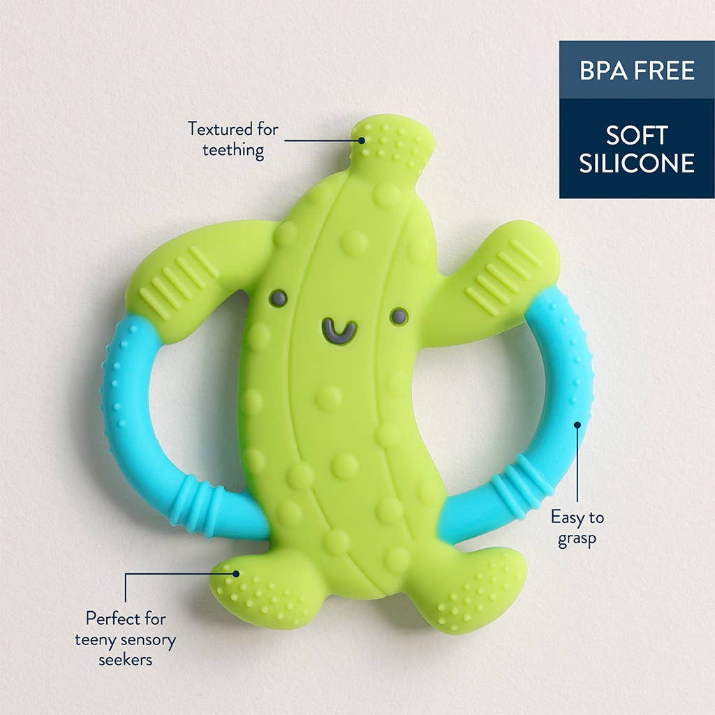 Green and blue silicone teething pickle toy with text highlighting features on a light gray background