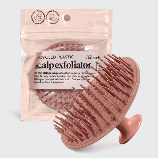 Pink scalp exfoliator with packaging on a light gray background
