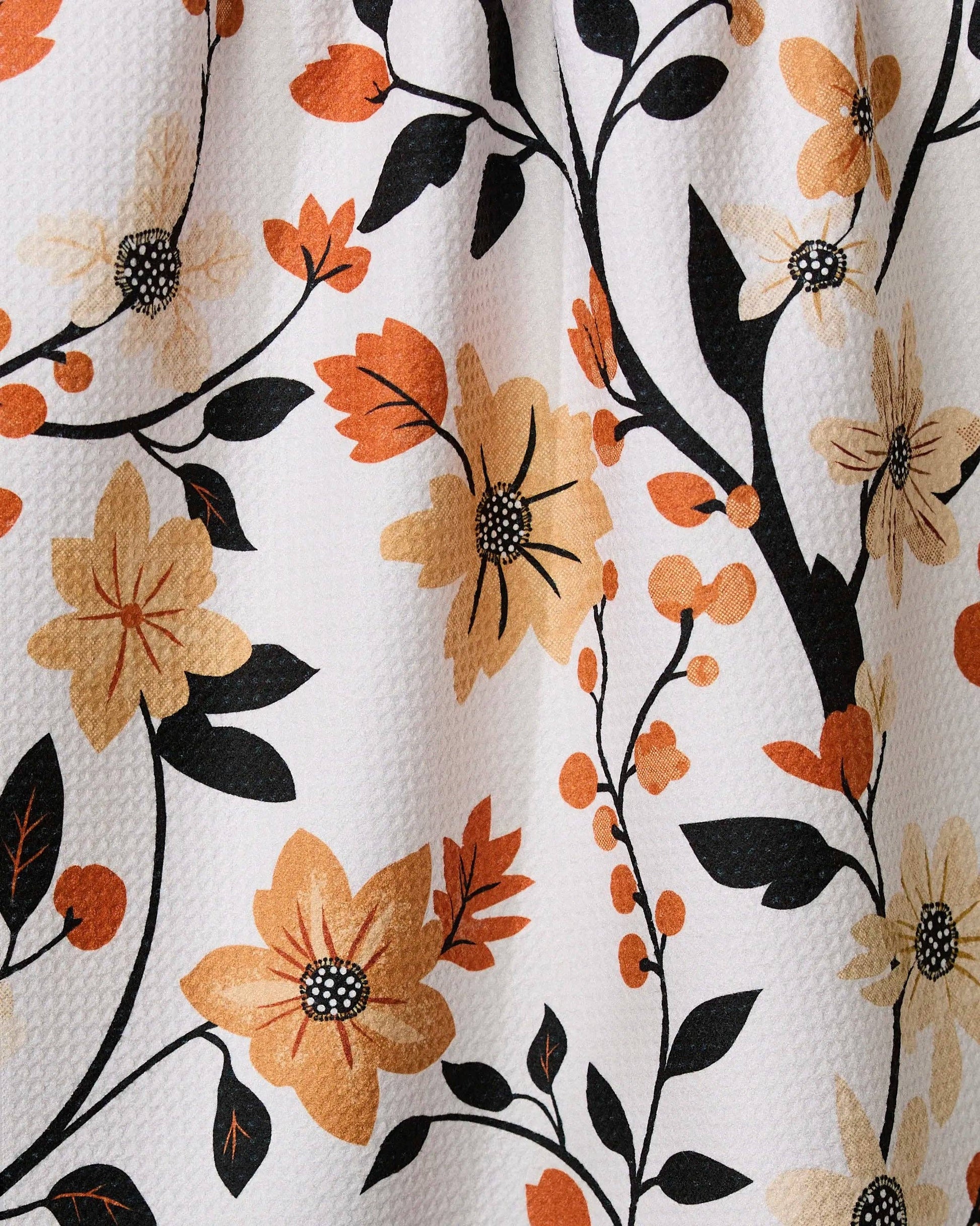Geometry kitchen tea towel with floral pattern with orange, black, and beige flowers on a white background