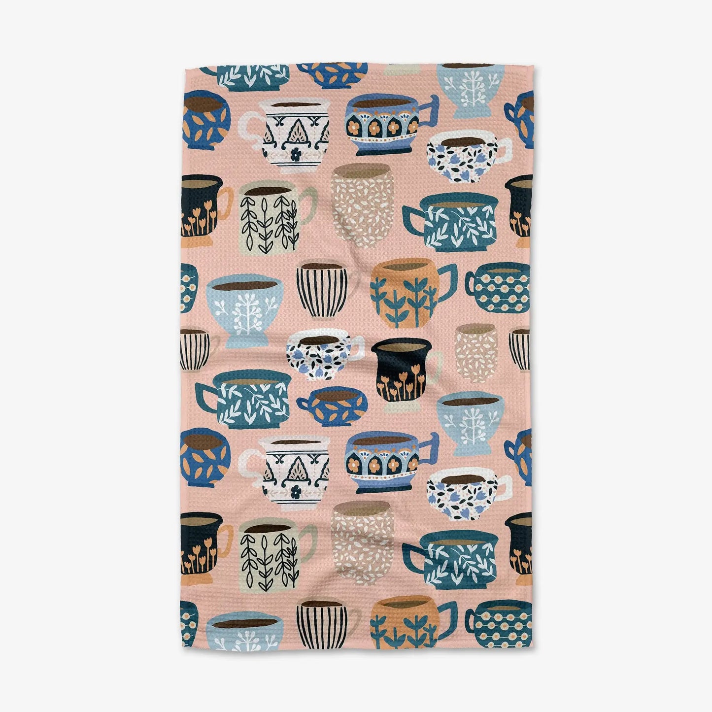 Patterned Geometry tea towel with colorful mugs on a pink background