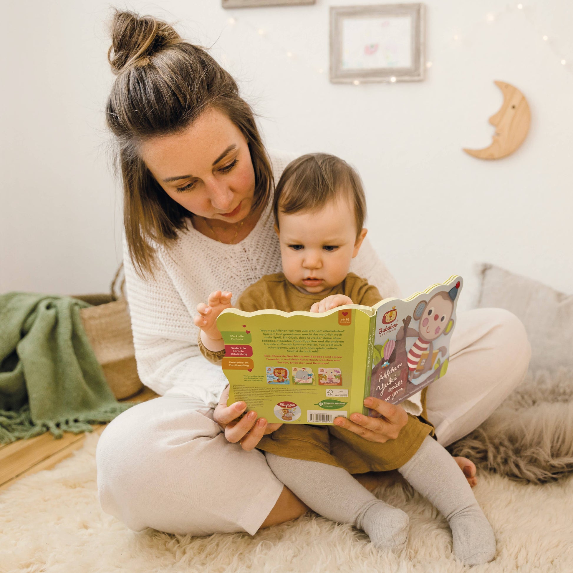 Woman reading a book to a child in a cozy room