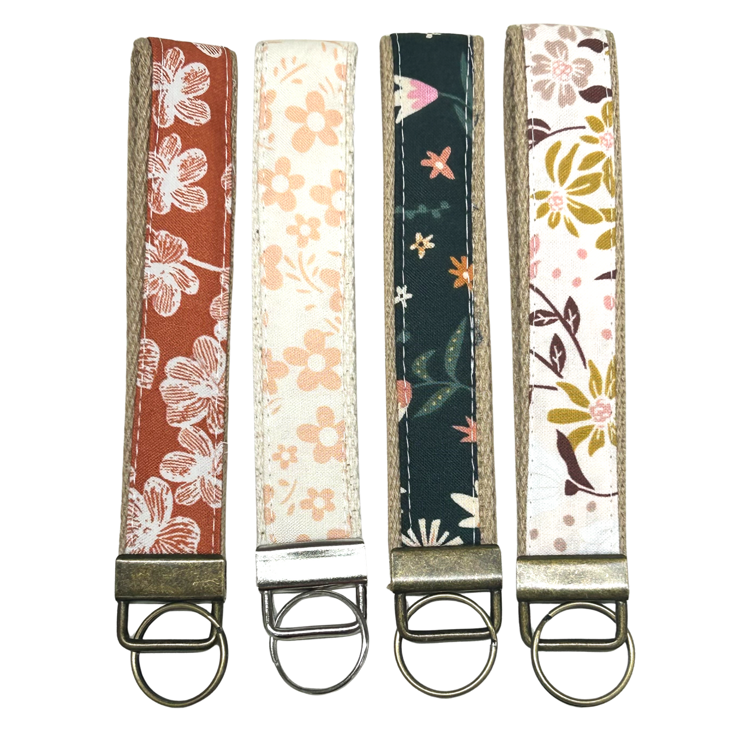 Four floral-patterned keychains on a white background
