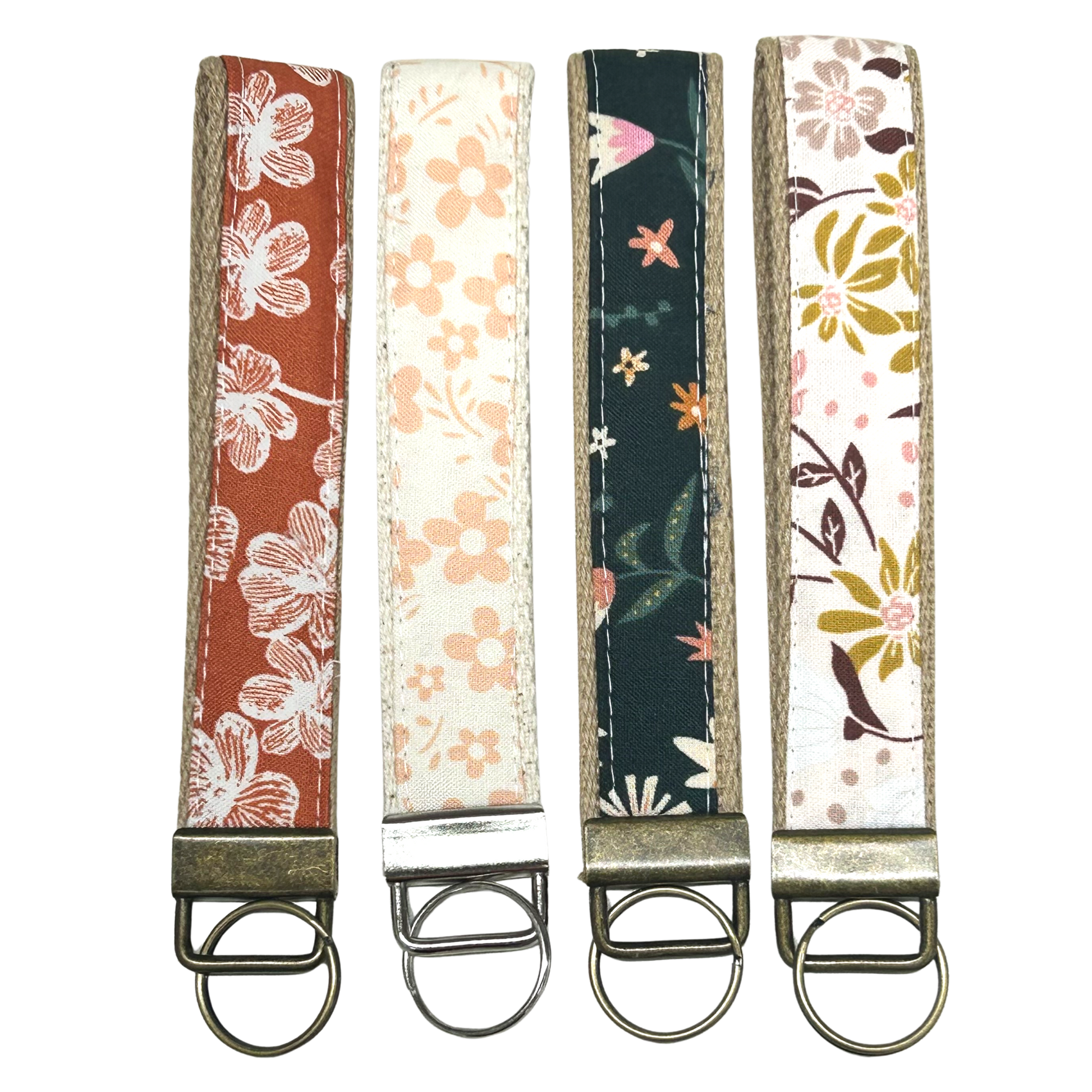 Four floral-patterned keychains on a white background