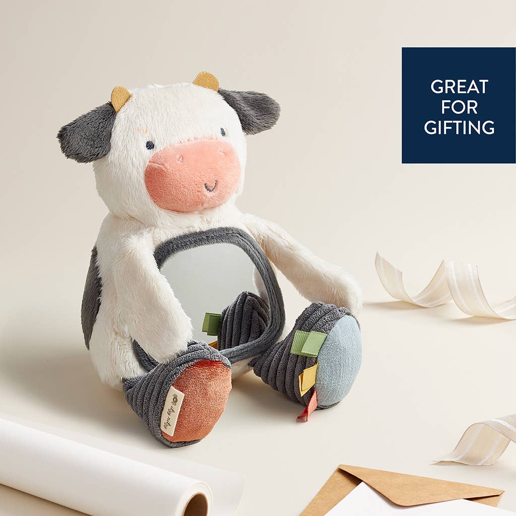 Plush cow toy with colorful legs on a light background, labeled 'Great for Gifting'.