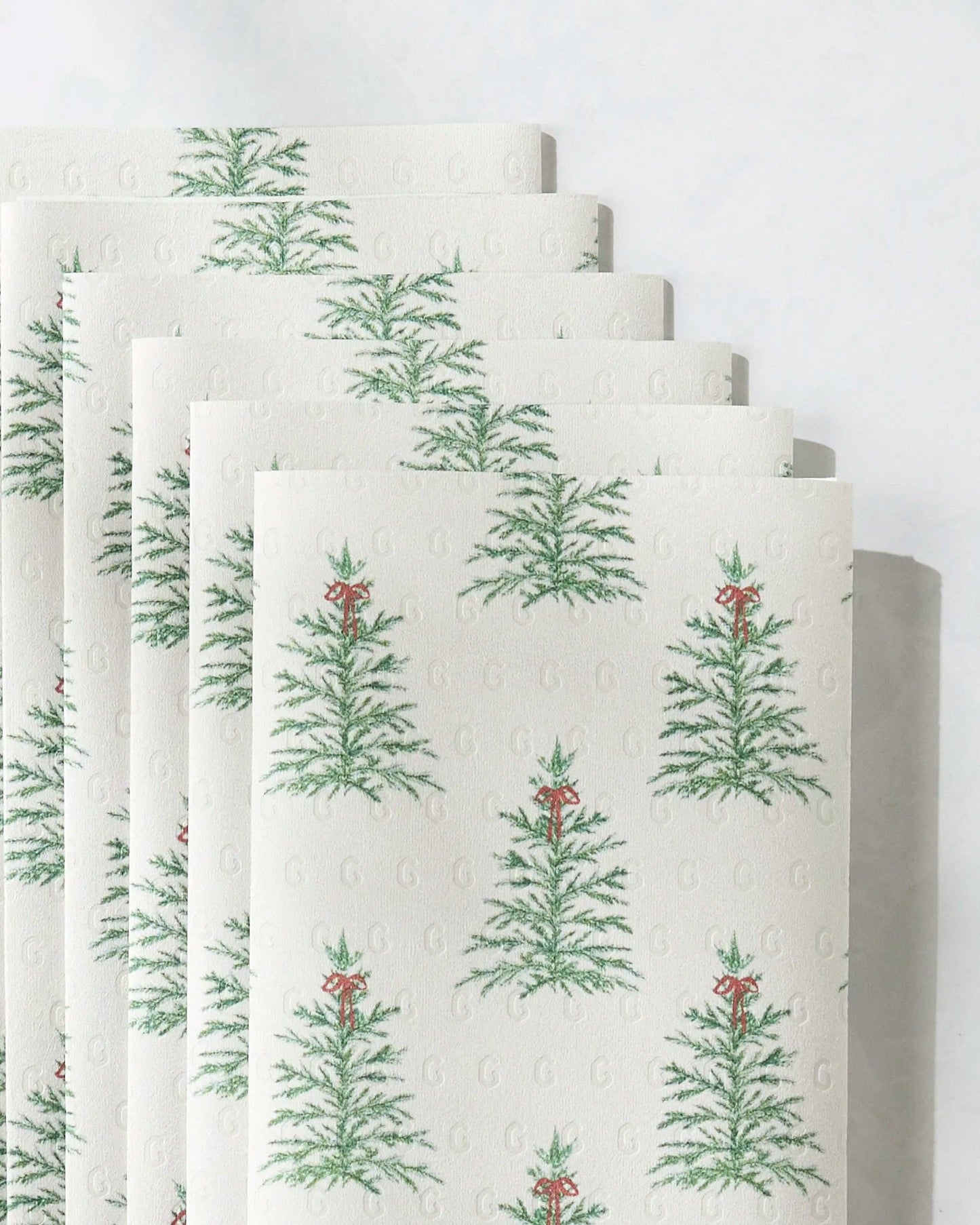 Geometry Not Paper Towel Set of six white towels with green tree pattern on a white background