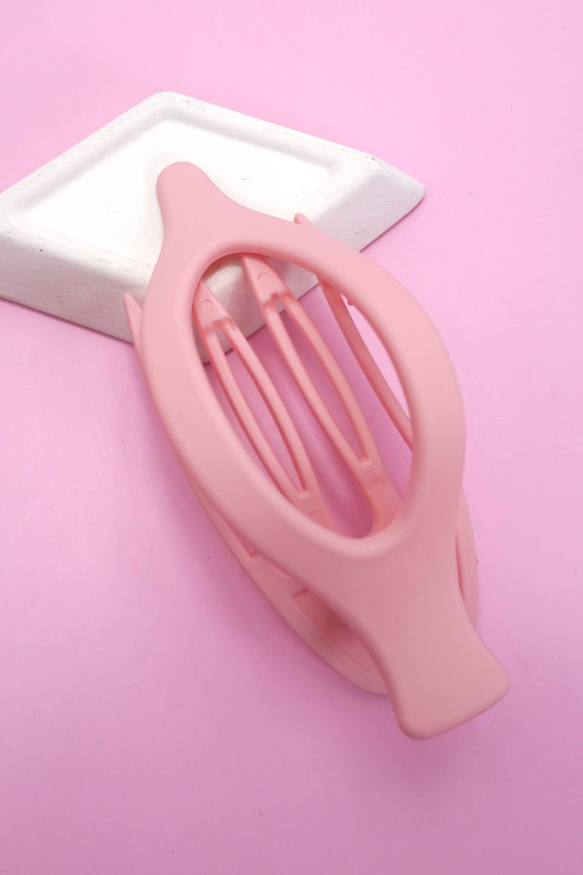 Pink hair clip on a pink background
