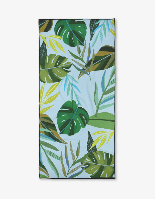 Towel with tropical leaf pattern on a light blue background
