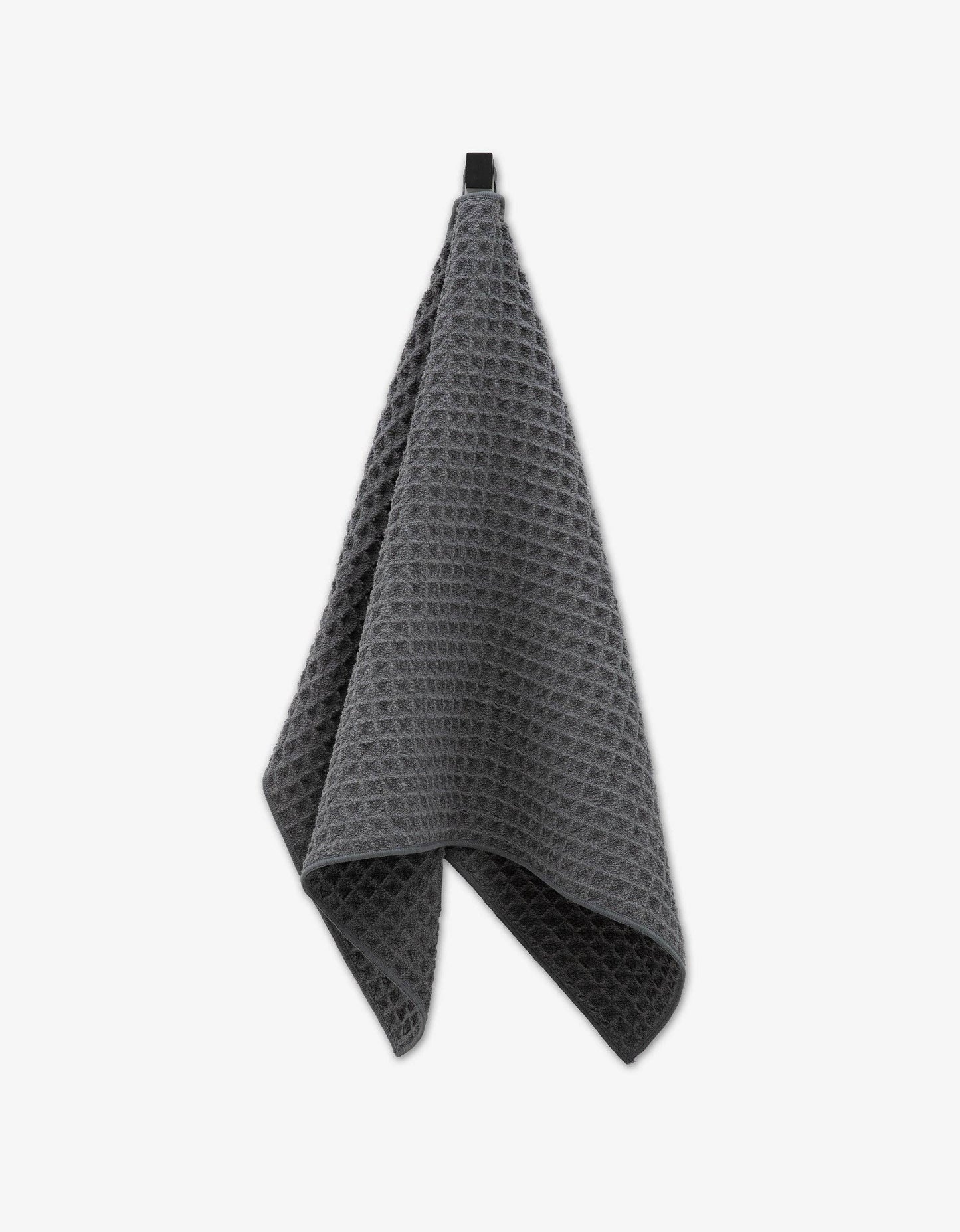 Geometry waffle-textured towel gray on a white background