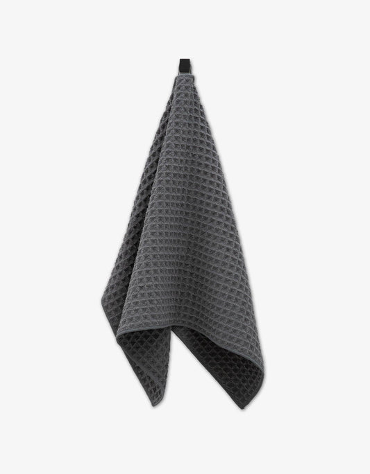 Geometry waffle-textured towel gray on a white background
