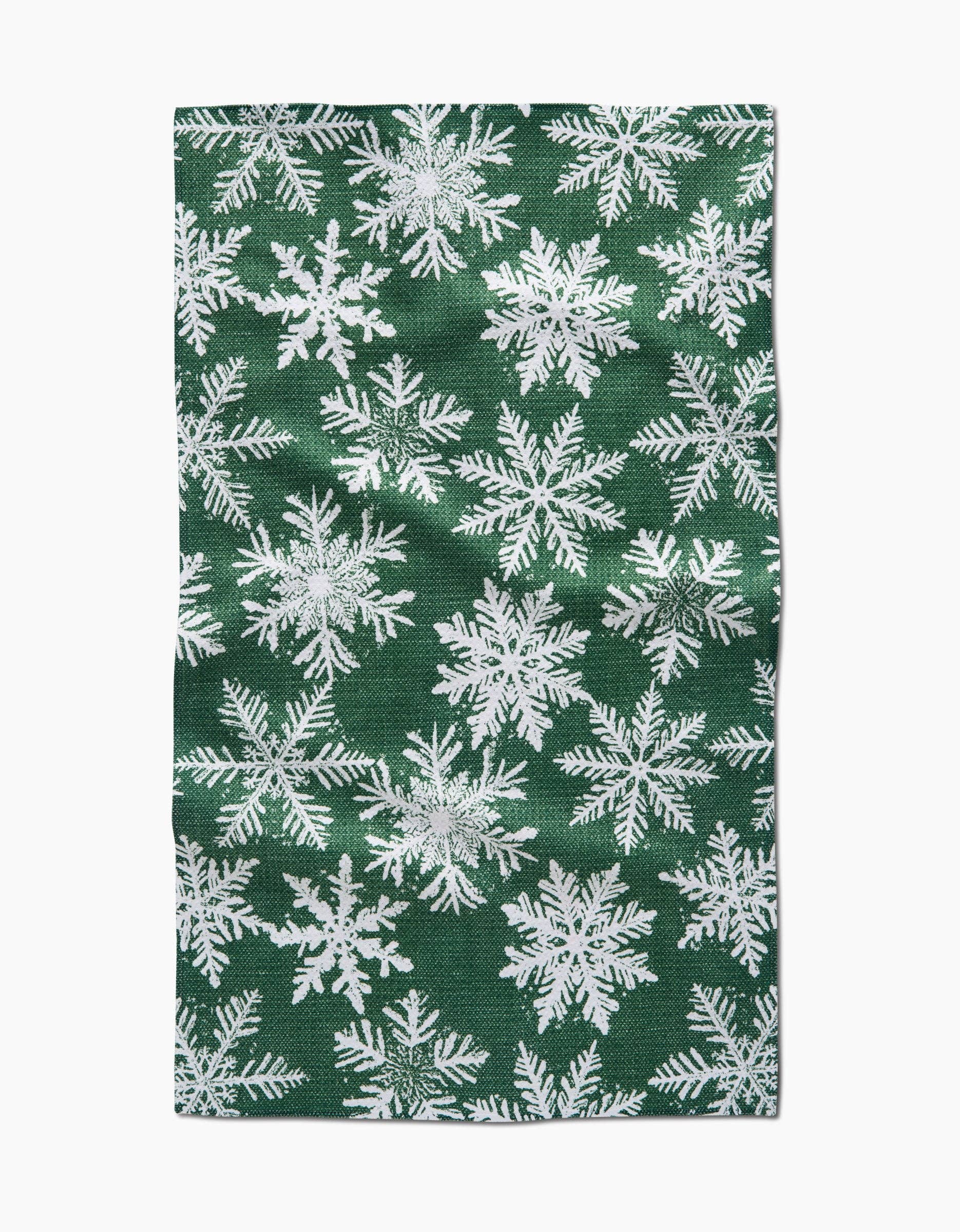 Green fabric with white snowflake pattern