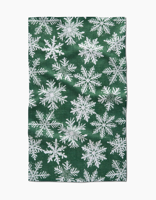 Green fabric with white snowflake pattern