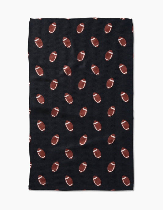 Black Geometry brand kitchen tea towel with brown football pattern on a white background