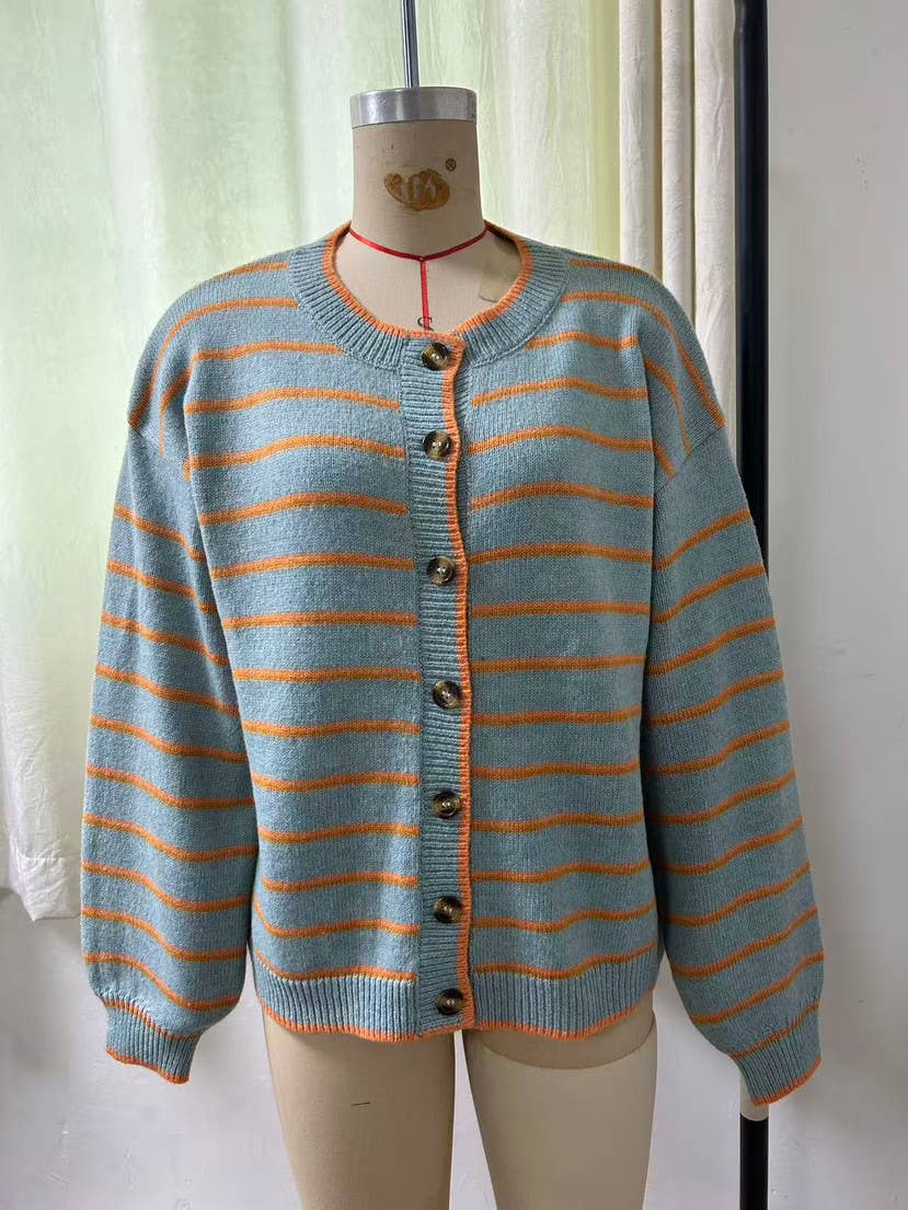 A light blue-gray knit cardigan sweater with orange horizontal stripes, displayed on a beige dress form mannequin. The cardigan features a round neckline, dark brown buttons, and ribbed cuffs and hem.