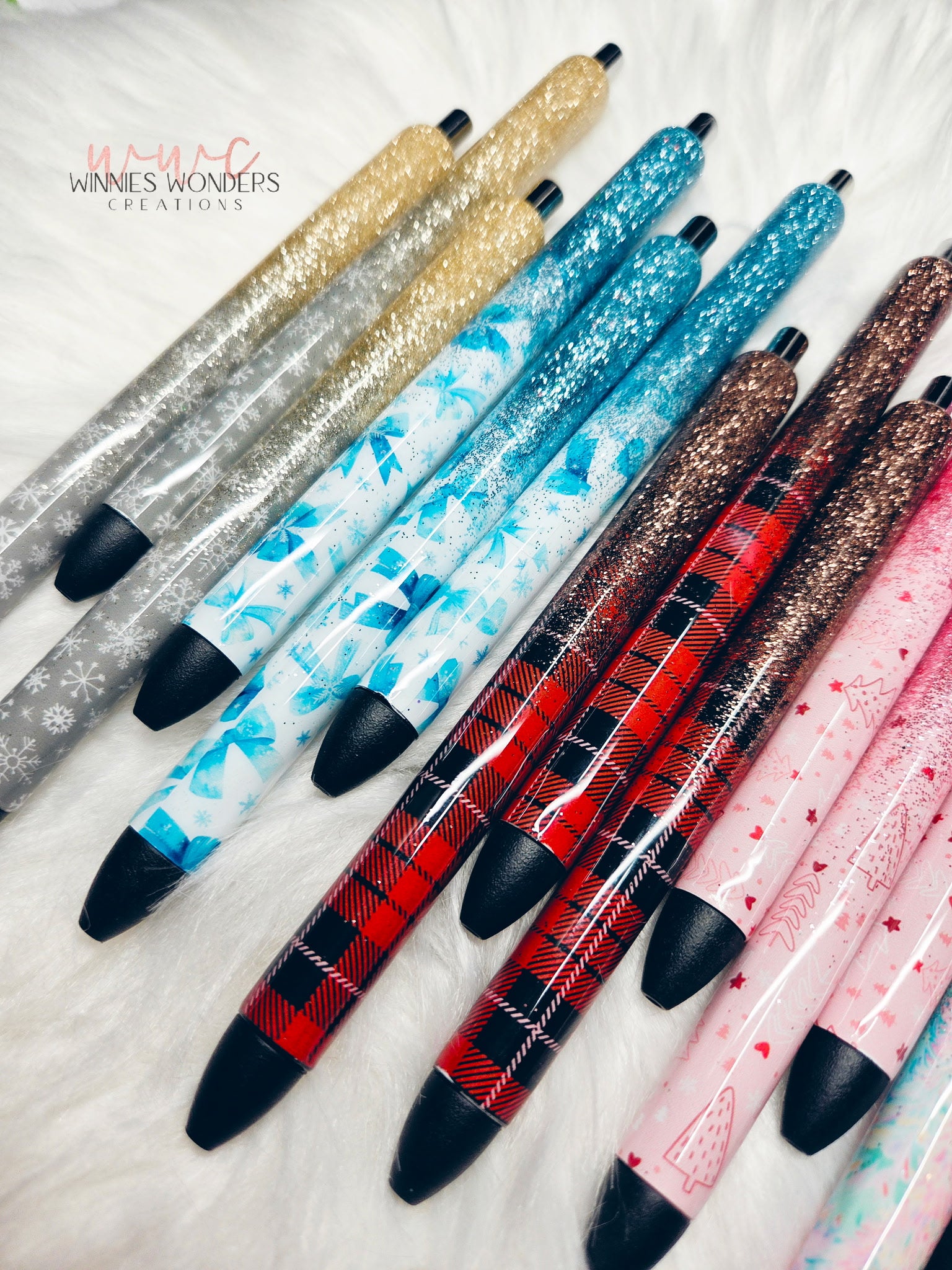 Colorful pens with various designs on a textured surface