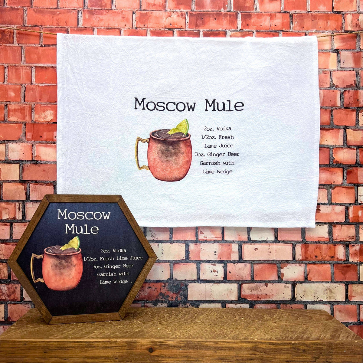 Moscow Mule tea towel against a brick wall background