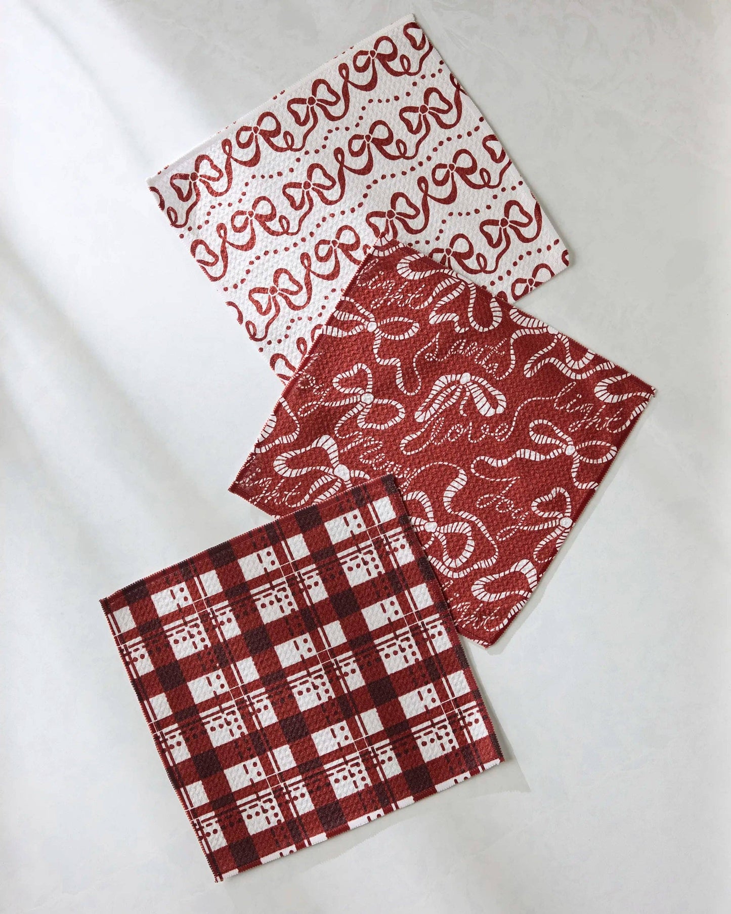 Geometry Dishcloth Set of three fabric swatches with different patterns on a white background