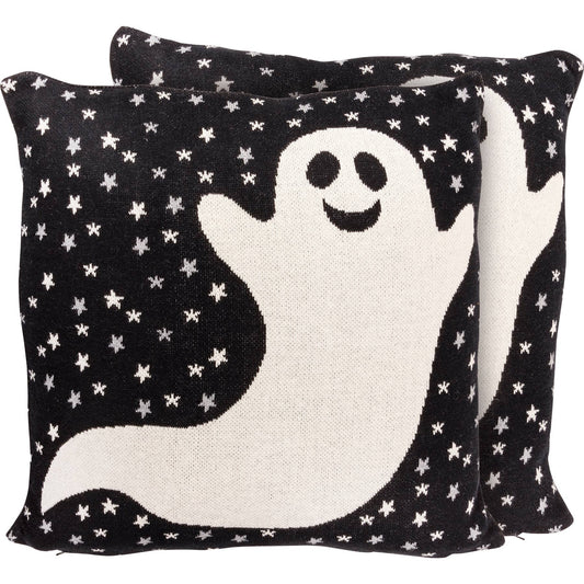 Decorative pillow with a ghost design on a black background with white stars