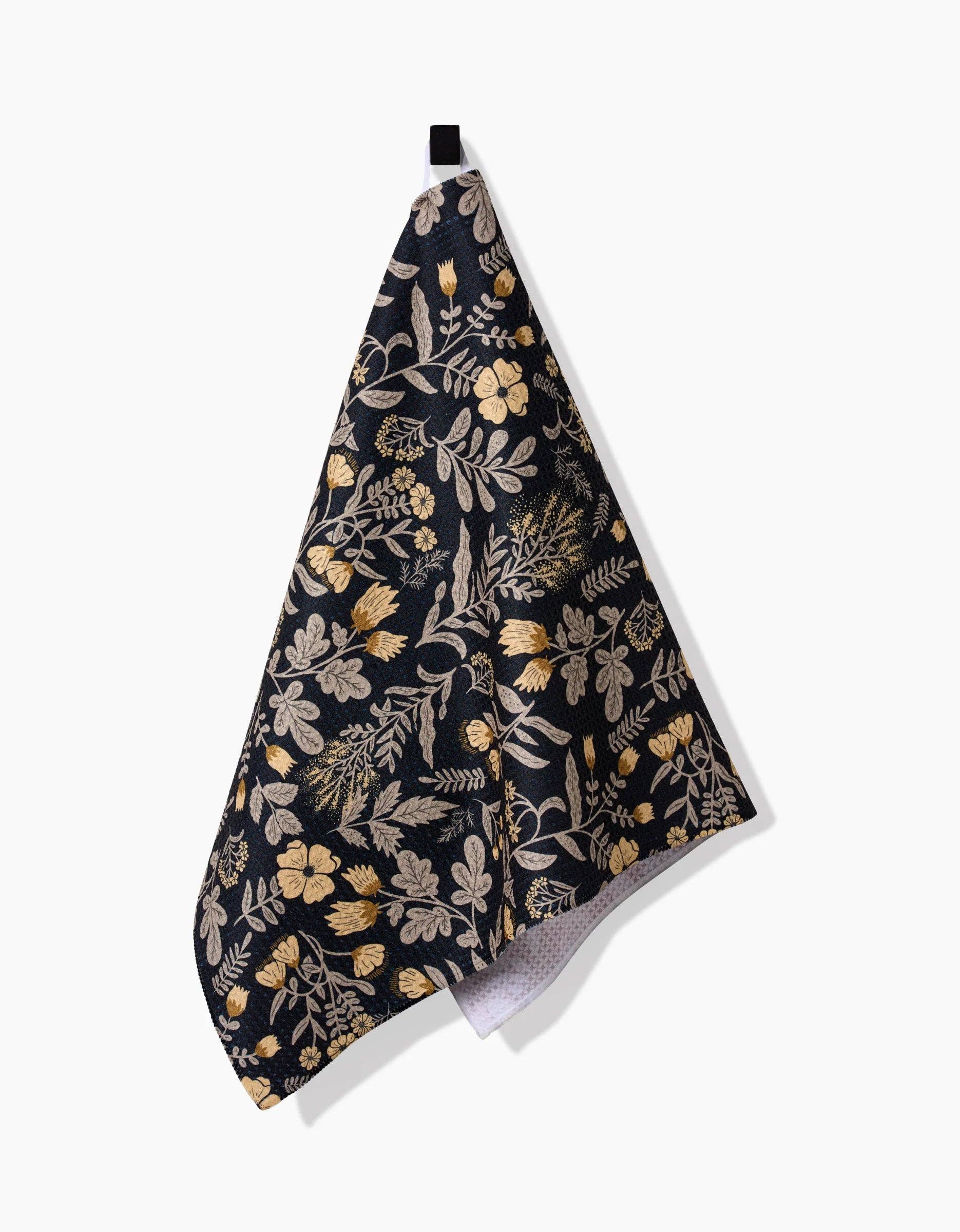 Geometry kitchen tea towel with floral patterned fabric on a black background
