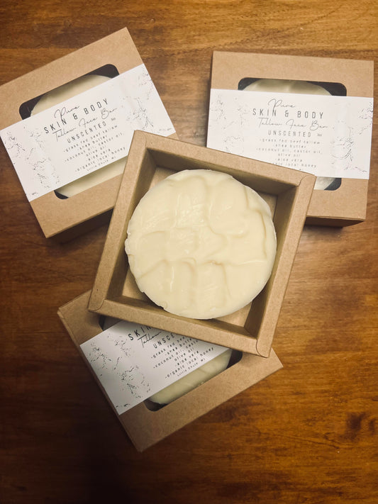Three bars of soap in cardboard boxes on a wooden surface, with 'Skin & Body' labels.