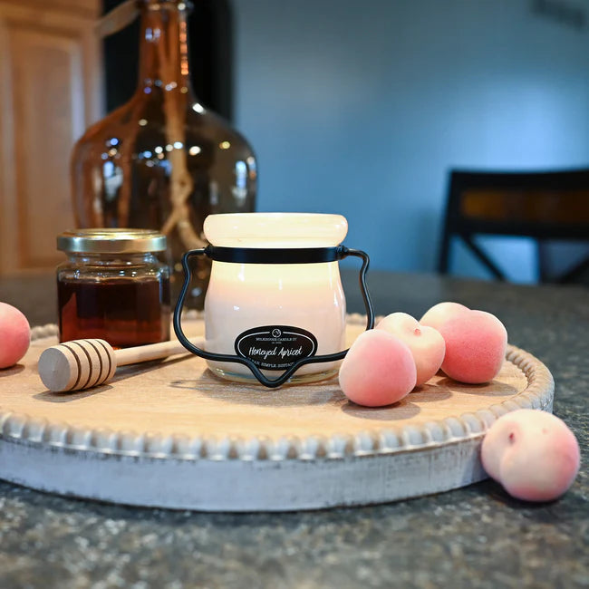Milkhouse Candle 5 oz Glass Cream Jar with honey and apricots on a white tray in a kitchen on a countertop