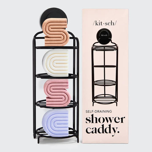 Black self-draining shower caddy with colorful soap dishes next to its packaging on a light gray background.