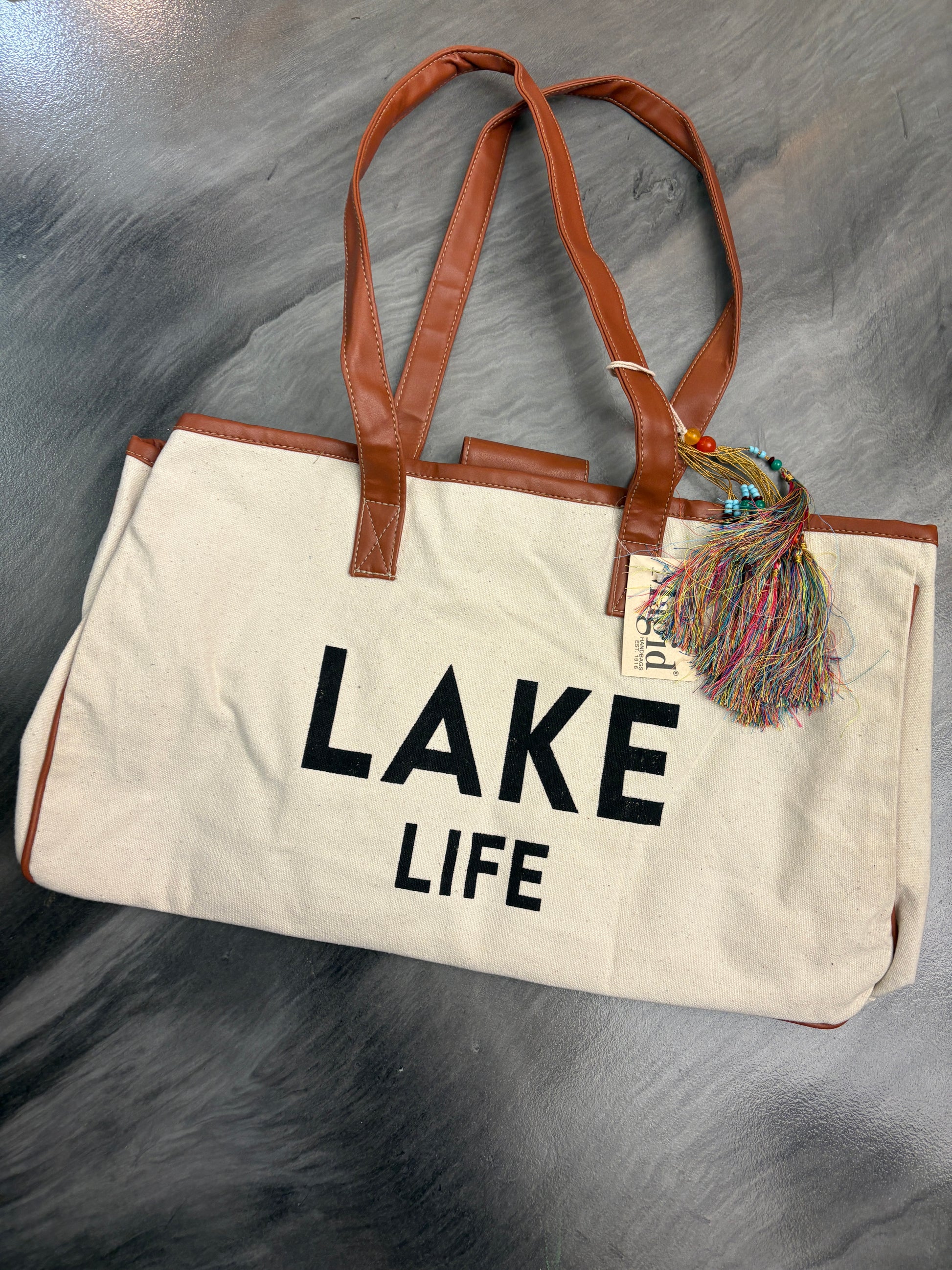 Tote bag with 'Lake Life' text on a gray surface