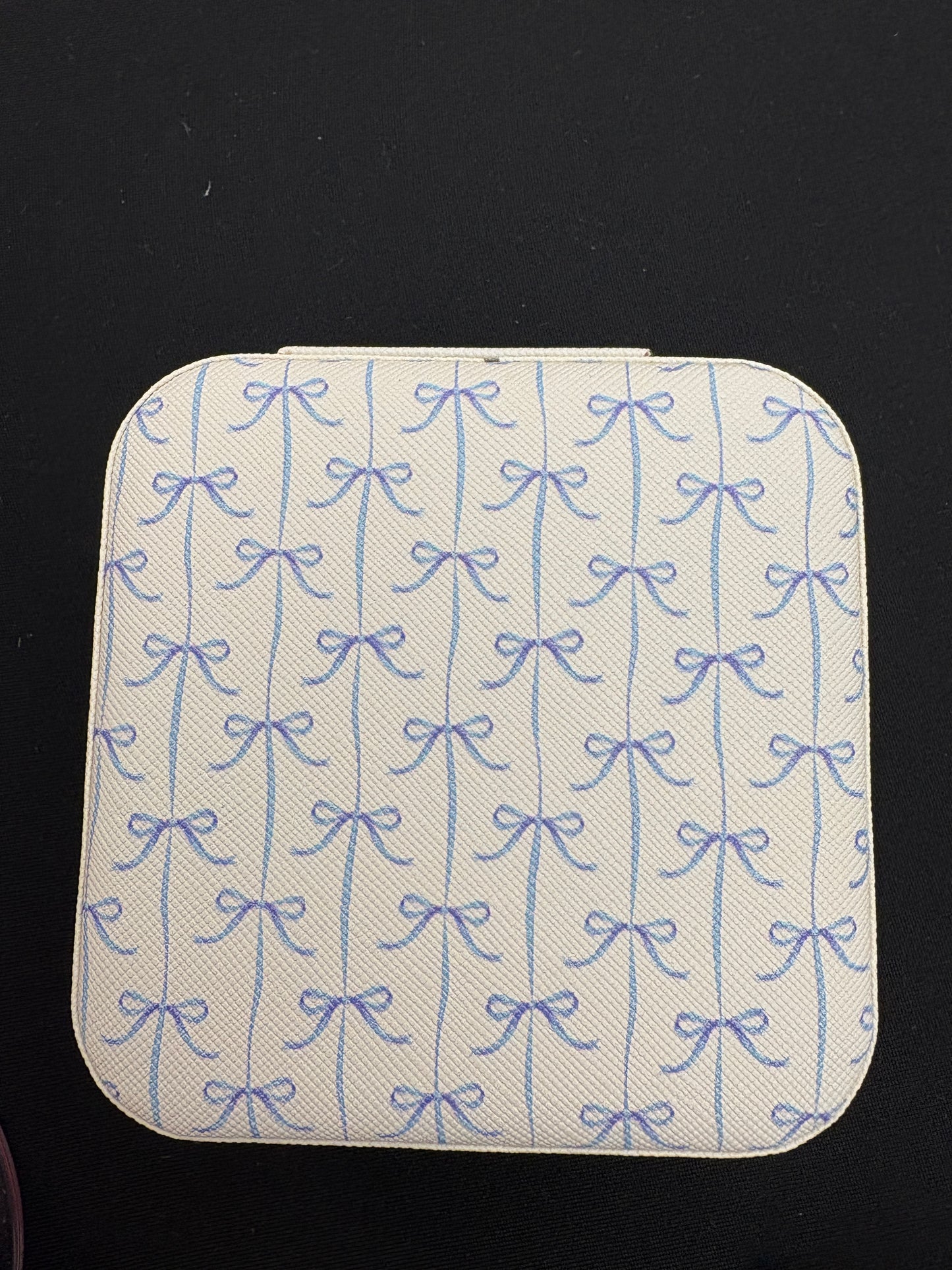 Square jewelry with blue pattern on a black background