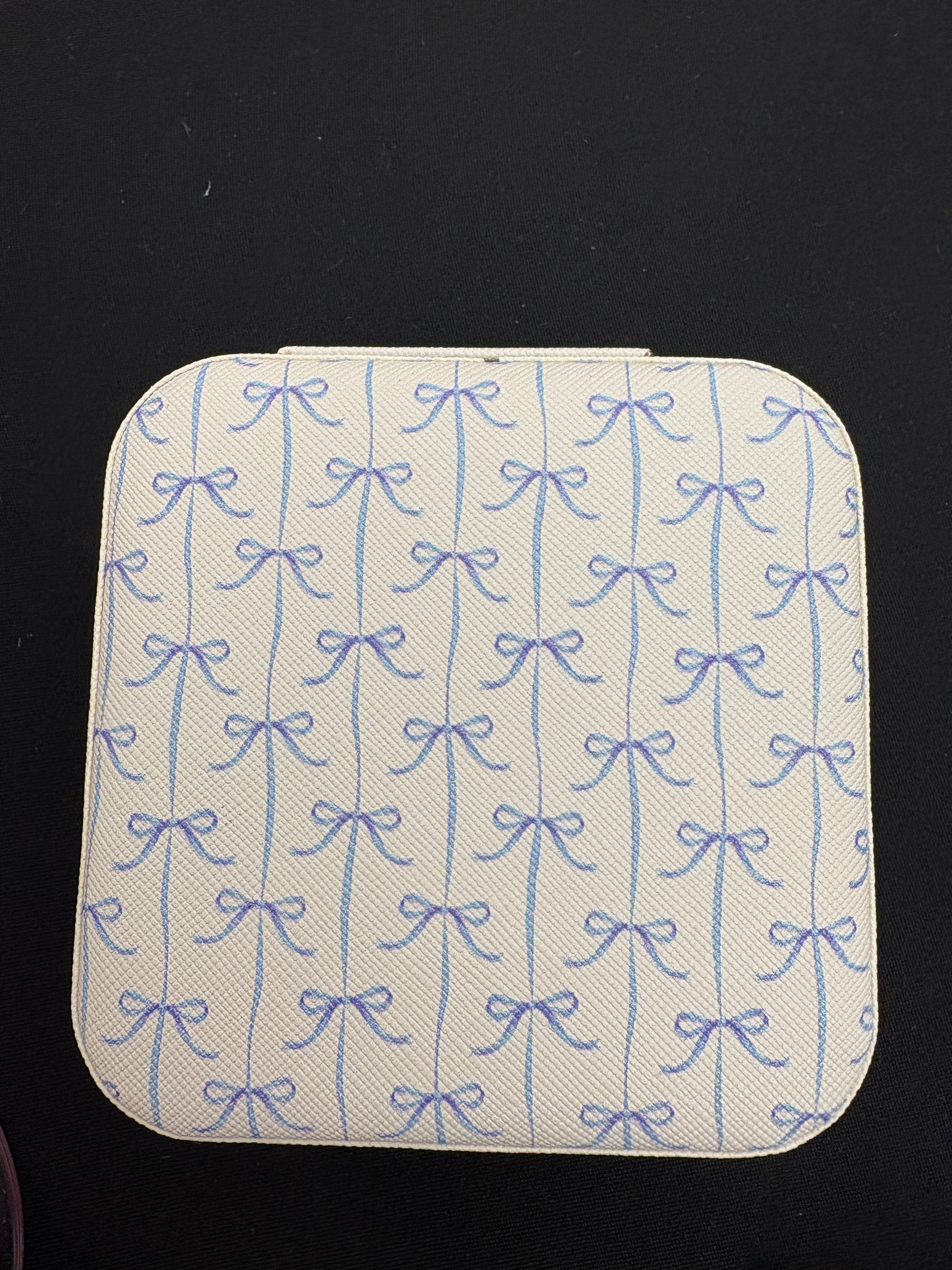 Square jewelry with blue pattern on a black background