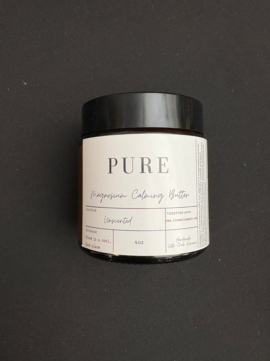 A jar of Pure magnesium calming butter skincare product on a dark background.