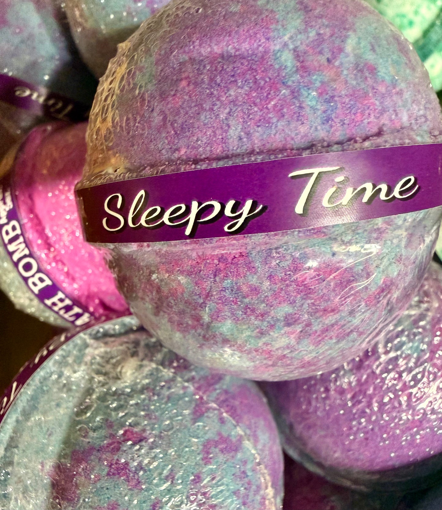 Bath bomb with 'Sleepy Time' label among other bath bombs.