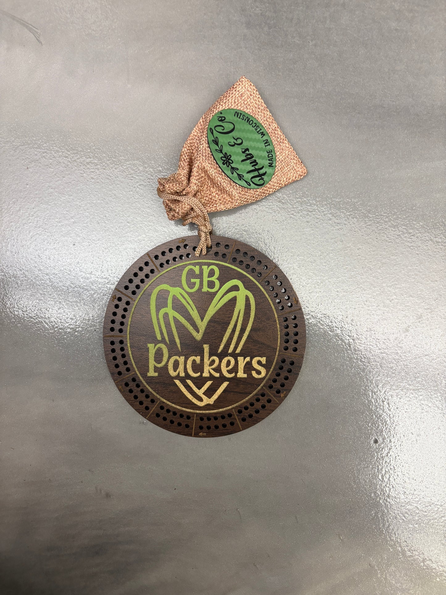 Packers heart logo on cribbage board.