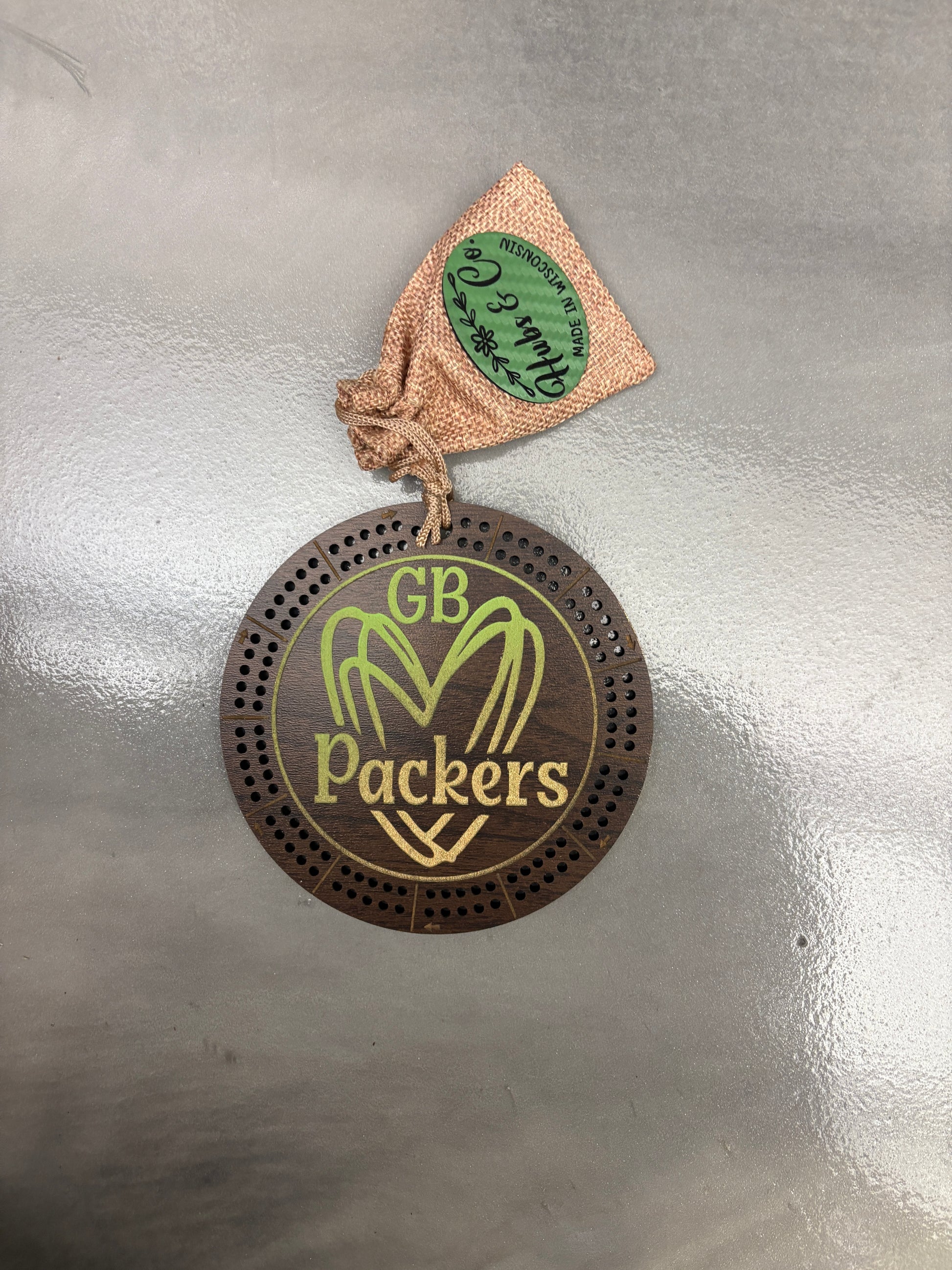 Packers heart logo on cribbage board.