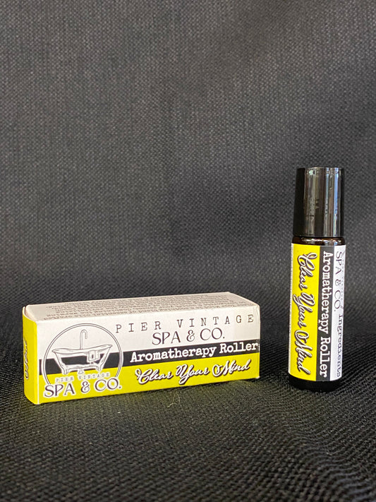 Aromatherapy roller with packaging on a textured surface