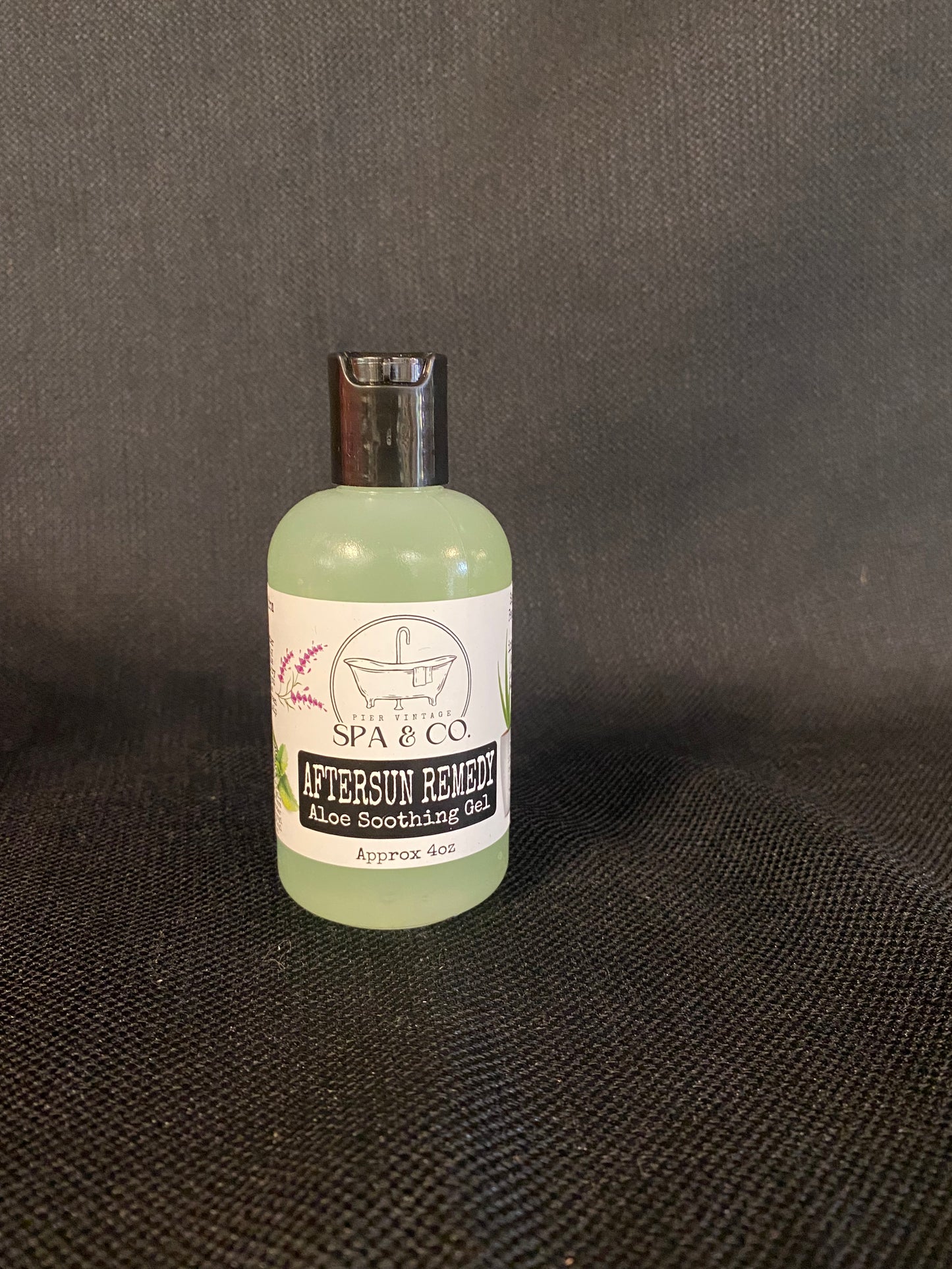 Pier Vintage Spa & Co AfterSun Remedy Aloe soothing gel in a clear bottle with white label on black textured background